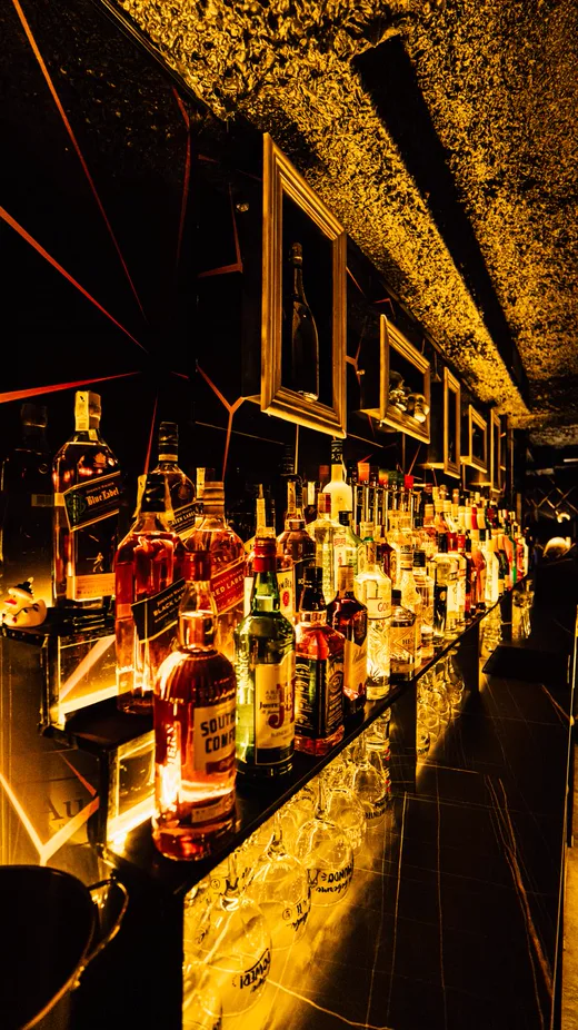The bar, lit like a jewellery shop.