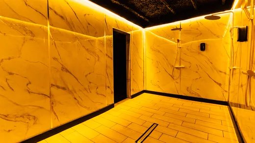 Marble showers bathed in golden light.